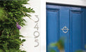 modern avalon door knocker on a blue door